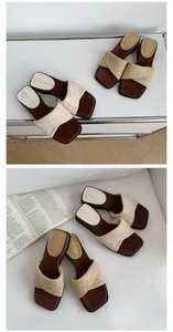 Detail view of chic beige braided slides with brown square soles in a lifestyle setting