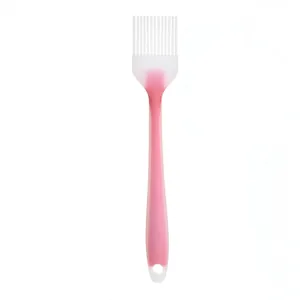 High-quality pink silicone basting brush for cooking and grilling on white background