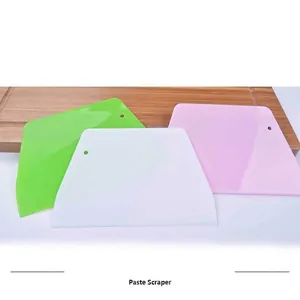 Set of three food-grade trapezoidal plastic dough scrapers in white, green, and pink.