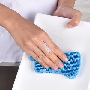 Efficient blue PE dish scrubber cleaning a white ceramic plate with rich soapy foam