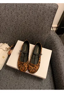 Close-up view of leopard print Mary Jane ballet flats featuring a black T-strap design