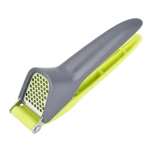 Ergonomic garlic press with gray plastic handle and stainless steel masher for kitchen use