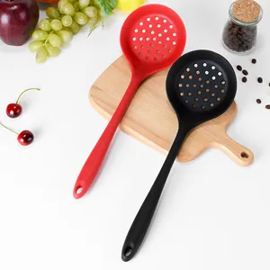 Heat-resistant silicone slotted spoons in red and black for kitchen cooking and serving
