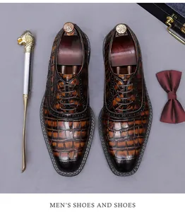 Detailed view of men's Oxford dress shoes with luxury crocodile pattern and leather texture.