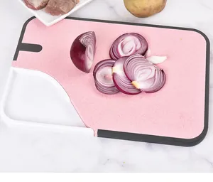 Close-up view of pink wheat straw cutting board with a built-in vegetable grinder