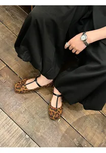 Close-up of leopard print Mary Jane flats with retro round toe and T-strap design.