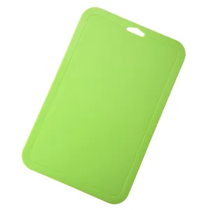 Vibrant green plastic cutting board for fruit and baby food supplement preparation.