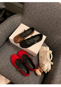 Top view of vintage round toe Mary Jane flats in leopard, black, and red