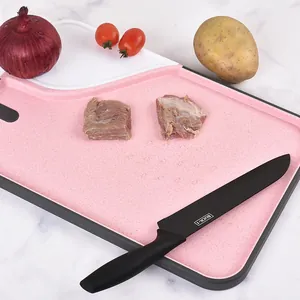 Pink wheat straw cutting board with built-in grinder and non-slip edge for kitchen