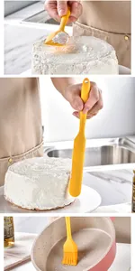 Yellow silicone baking tool set showing spatula spreading cream on cake and oil brush in pan
