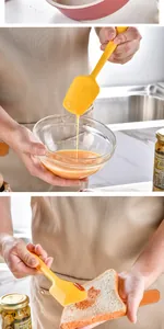 Close-up detail of a yellow silicone spatula spreading jam on bread and mixing eggs