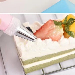 Close-up of professional stainless steel piping tip decorating a delicious cream cake