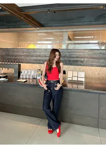 Full body view of a woman wearing red French vintage flat Mary Jane ballet shoes