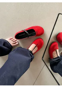 Detailed top view of vintage red suede Mary Jane flats with elegant black T-strap