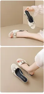 Close-up of elegant cream sandals with metallic buckle on an Asian model's feet