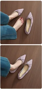 Detailed view of lavender suede pointed-toe ballet flats with retro bow decoration