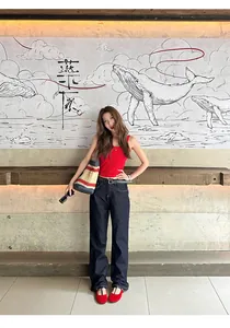 Lifestyle shot of model wearing red retro Mary Jane flats with casual denim outfit.