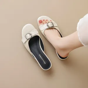 Retro cream buckle slides for women elegant summer sandals on neutral background
