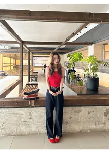 Full body shot of a model wearing red French vintage Mary Jane flats in a cafe