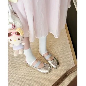 Detailed view of silver split-toe Tabi mules with elastic strap and metallic finish