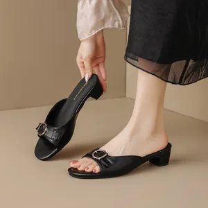 Elegant black block heel mule sandals with a decorative silver buckle for women