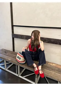 French vintage red round toe Mary Jane flats styled with casual denim jeans and red top.