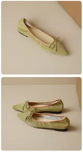 Close-up of vintage green suede pointed-toe flats with bow detail and brown piping