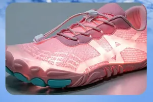 Detailed macro view of pink breathable mesh hiking shoe with speed lacing and LED glow