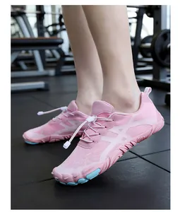 Lightweight pink breathable barefoot shoes for fitness and yoga worn on feet in gym