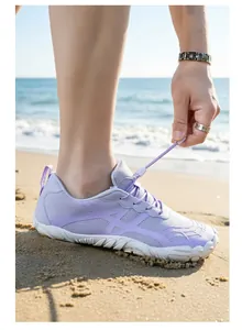 Detailed view of lightweight purple breathable outdoor hiking shoes on a sunny beach