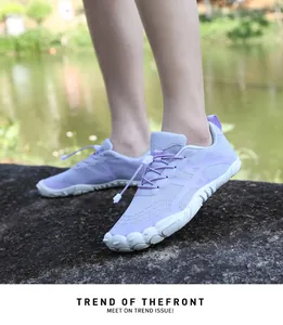 Detail shot of purple breathable outdoor hiking shoes worn by the water outdoors