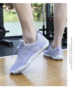 Detailed side view of breathable purple hiking shoes on model in a modern gym setting.