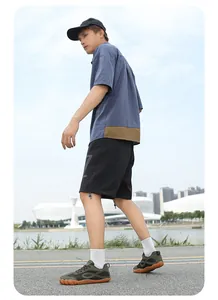 Foto lifestyle all'aperto di scarpe minimaliste traspiranti con punta larga su modello