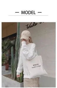 Lifestyle shot of a model wearing a large capacity cream white canvas tote bag