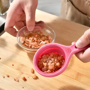 Pink silicone collapsible measuring cup with 60ml 1/4 cup capacity marking