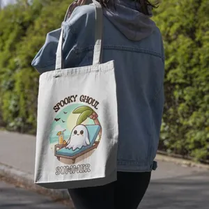 Outdoor lifestyle view of a women's canvas tote bag with spooky ghoul summer print