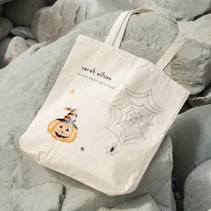 Detail of customization option and pumpkin print on Halloween canvas tote bag.