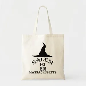 Close-up detail of cream canvas tote bag with black Salem 1626 witch hat graphic print