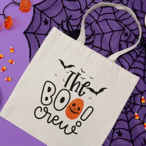 Detail view of white canvas Halloween tote bag featuring pumpkin and bat graphics