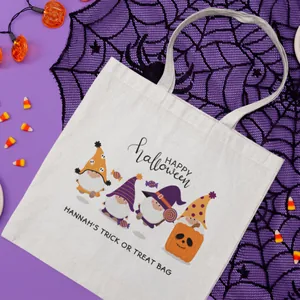 Detailed view of white canvas Halloween tote bag with festive gnomes and pumpkin patterns
