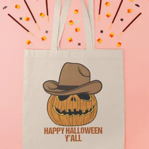 High-quality close-up of a Halloween pumpkin canvas tote bag with cowboy hat print and text