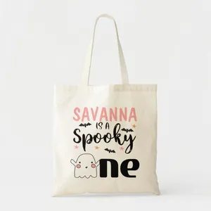 Detailed view of Halloween canvas tote bag featuring a cute ghost and spooky text design
