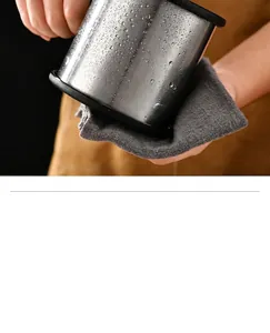Close-up of a stainless steel flour sifter with water droplets and a cleaning cloth