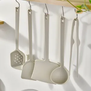 Juego de utensilios de cocina de silicona blanco crema colgados para sartenes antiadherentes