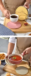 Detail view of pink and waffle-textured silicone trivets used for hot pans and coffee mugs