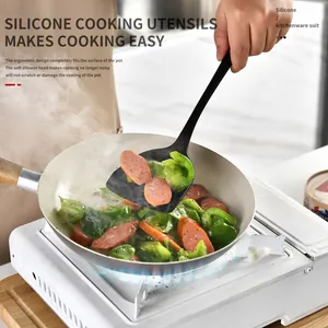 Heat-resistant black silicone spatula cooking utensil for non-stick pans in a home kitchen