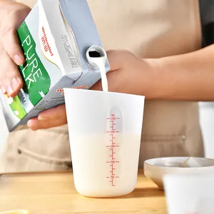 Silicone measuring cup with clear red scale markings for baking and pouring milk