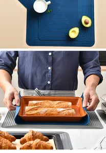 Detail view of navy blue silicone heat-resistant mat used as a kitchen tray holder