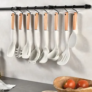 8-piece premium silicone kitchen utensil set with wooden handles on a hanging rack