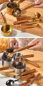 Detailed view of 8-piece stainless steel measuring cups and spoons set with wooden handles